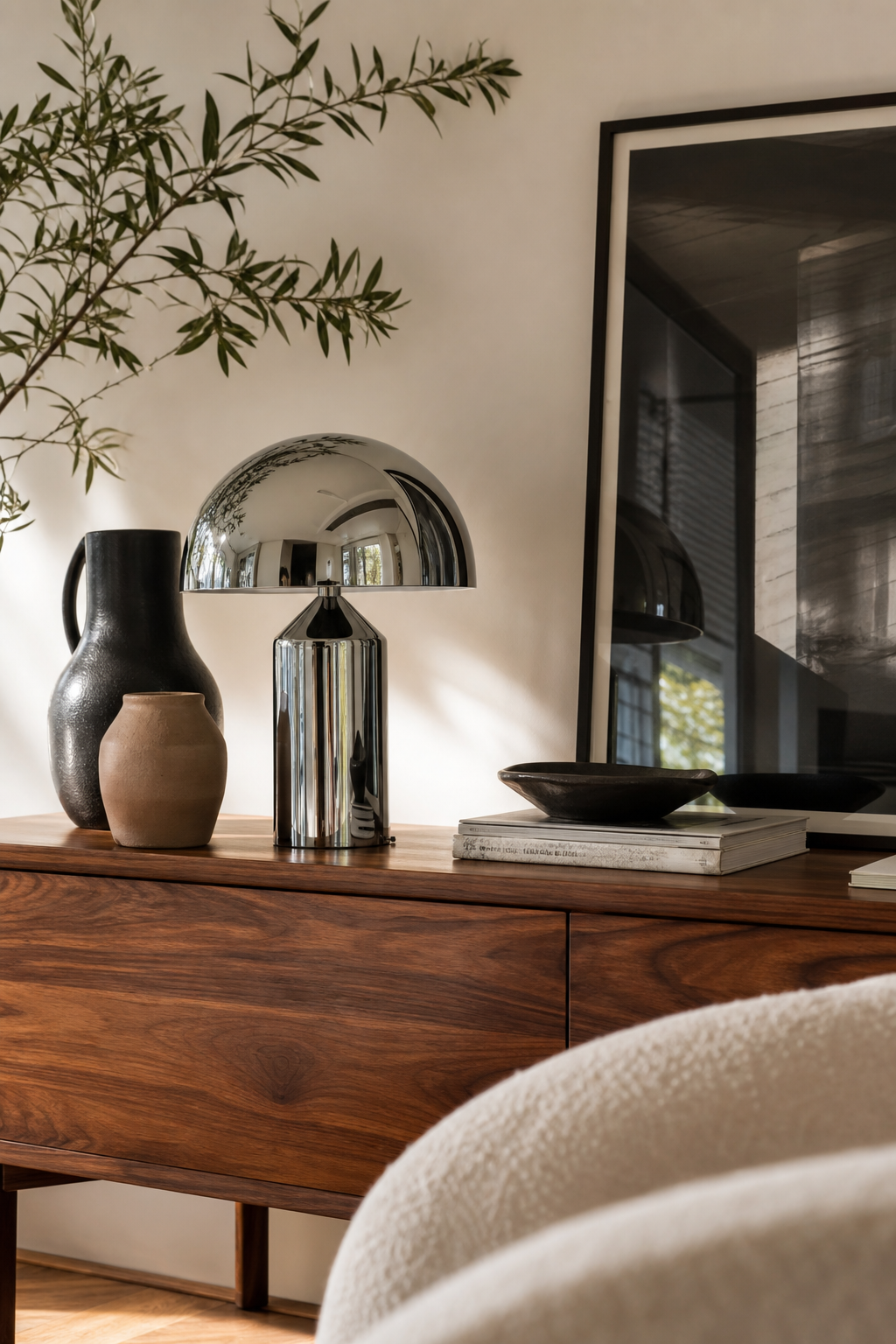 Chrome mushroom lamp adding shine to a walnut sideboard