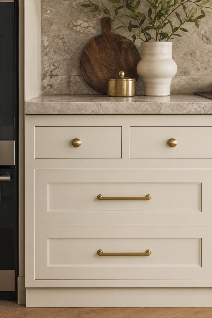 Cream kitchen cabinets with soft brass hardware