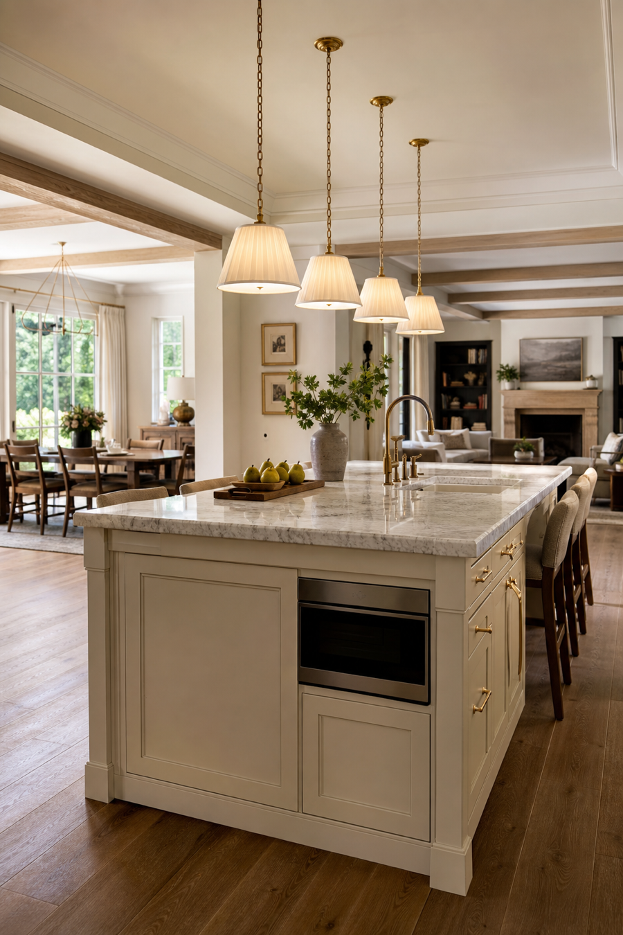 Open kitchen island defined by warm pendant lighting