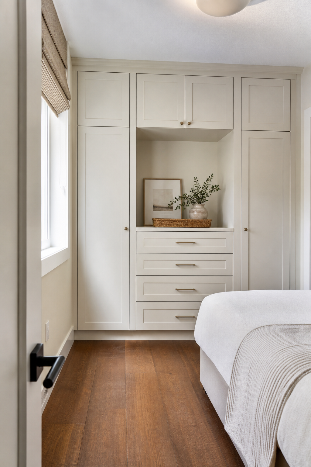 Small bedroom with dresser drawers integrated into a built-in closet wall
