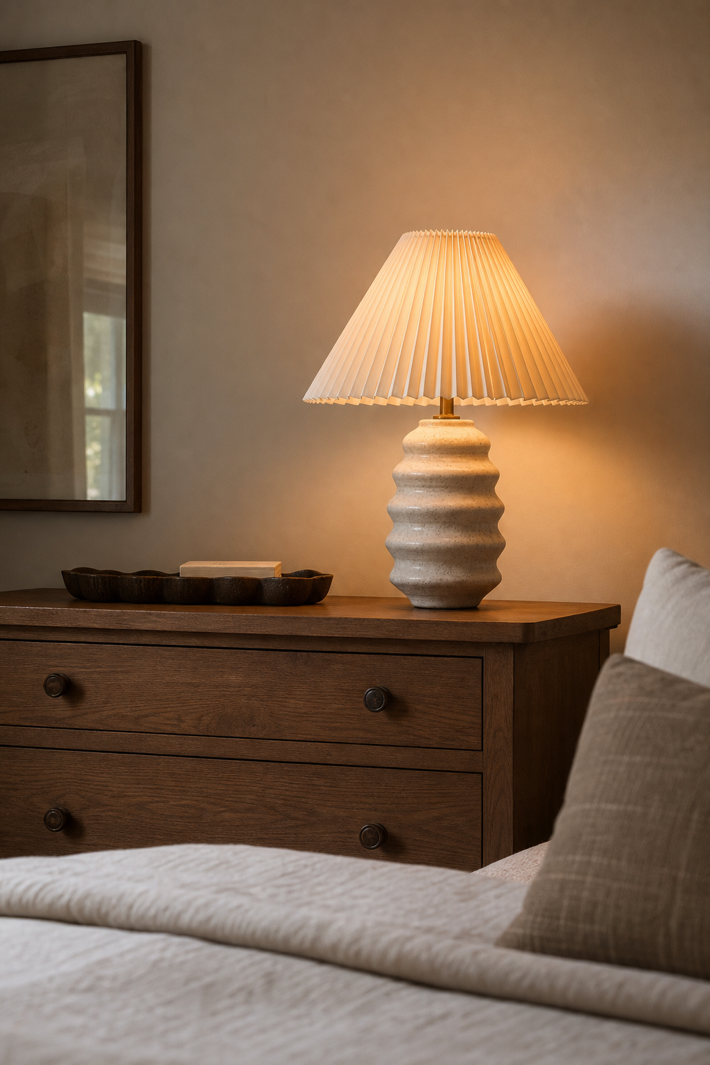 Small bedroom styled with one sculptural ceramic lamp